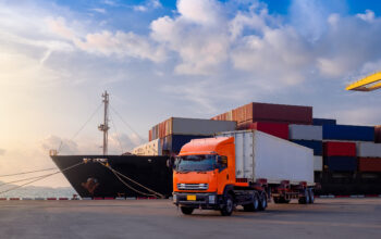 Muldtimodal trans The container vessel during discharging at an industrial port and move containers to container yard by trucks.