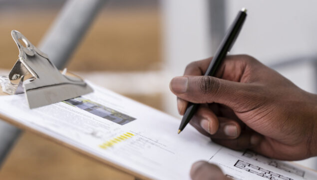 close-up-hand-filling-document