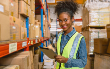 control entrepôt 2 woman worker black African girl teen working in cargo warehouse inventory employee staff portrait happy smile