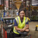 Woman leaning on a tow tractor in a distribution warehouse