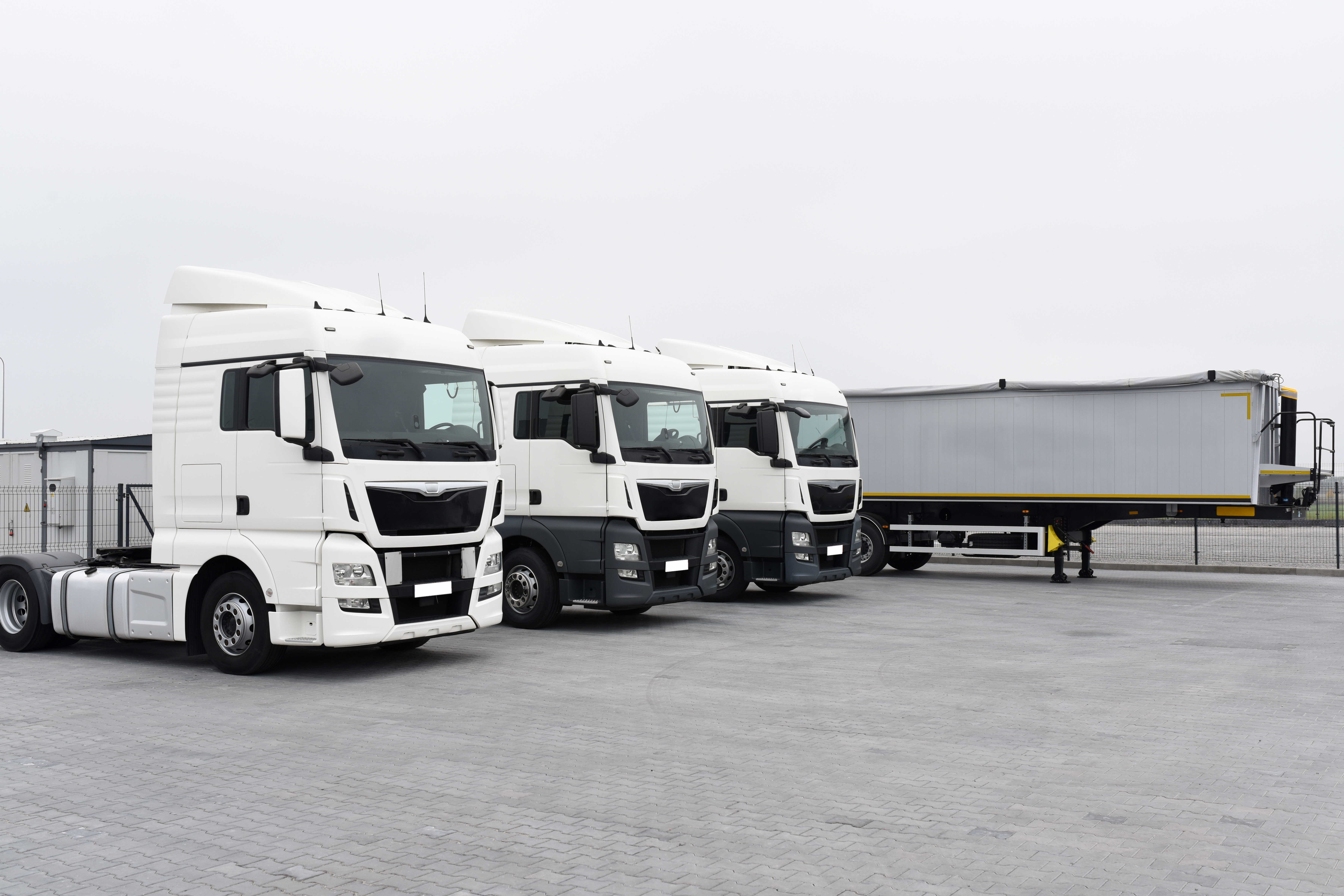 Trucks with cargo trailers in the parking lot, Freight transport by road, Logistics and transport.
