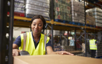 Woman using a barcode reader in a distribution warehouse Woman using a barcode reader in a distribution warehouse