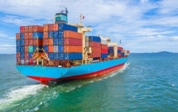 Container ship leaving the industrial port, Import and export bu Container ship leaving the industrial port, Import and export business logistic and transportation of international by container ship in the open sea.