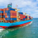 Container ship leaving the industrial port, Import and export business logistic and transportation of international by container ship in the open sea.